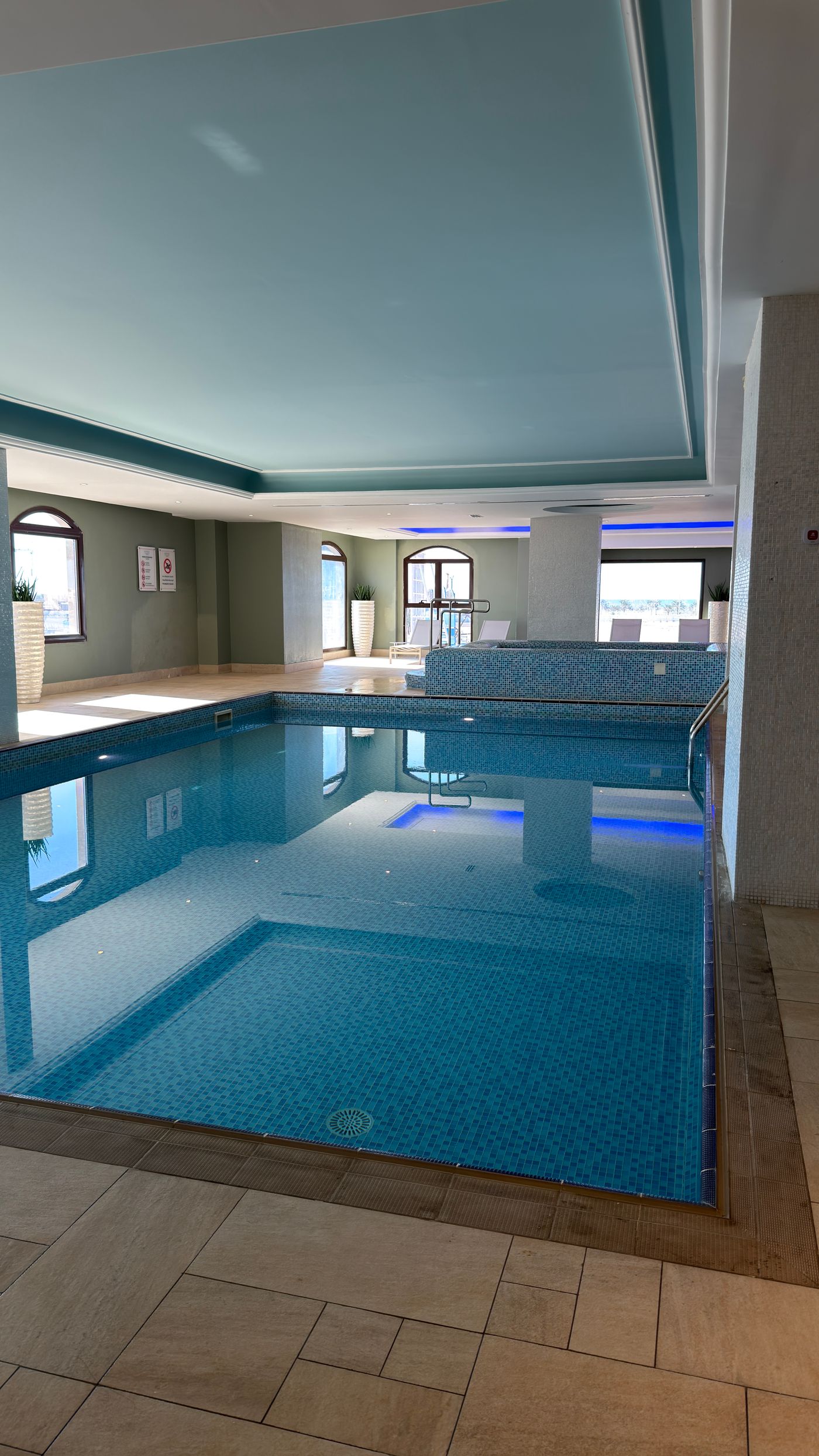 Illustrative indoor pool with ambient lighting, not the actual property