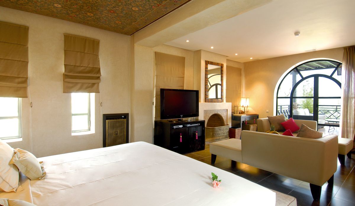 Illustrative garden-facing suite with natural light and a fireplace, not the actual property
